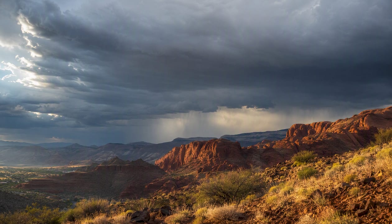Monsoon storm forming over red rock plateau