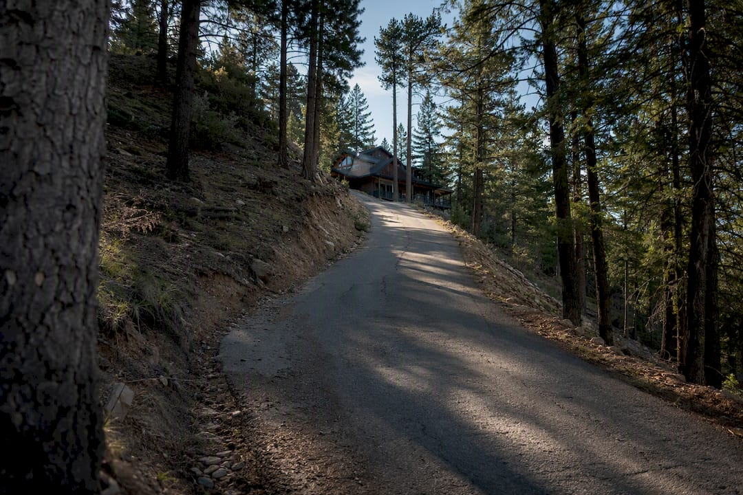 Steep paved mountain driveway leading to cabin